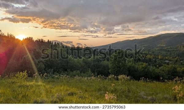 Golden sunset settling over a quiet green valley